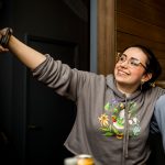 mom and two teens posting for a selfie at Axel's Throw House