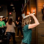 woman throwing an axe at axel's throw house